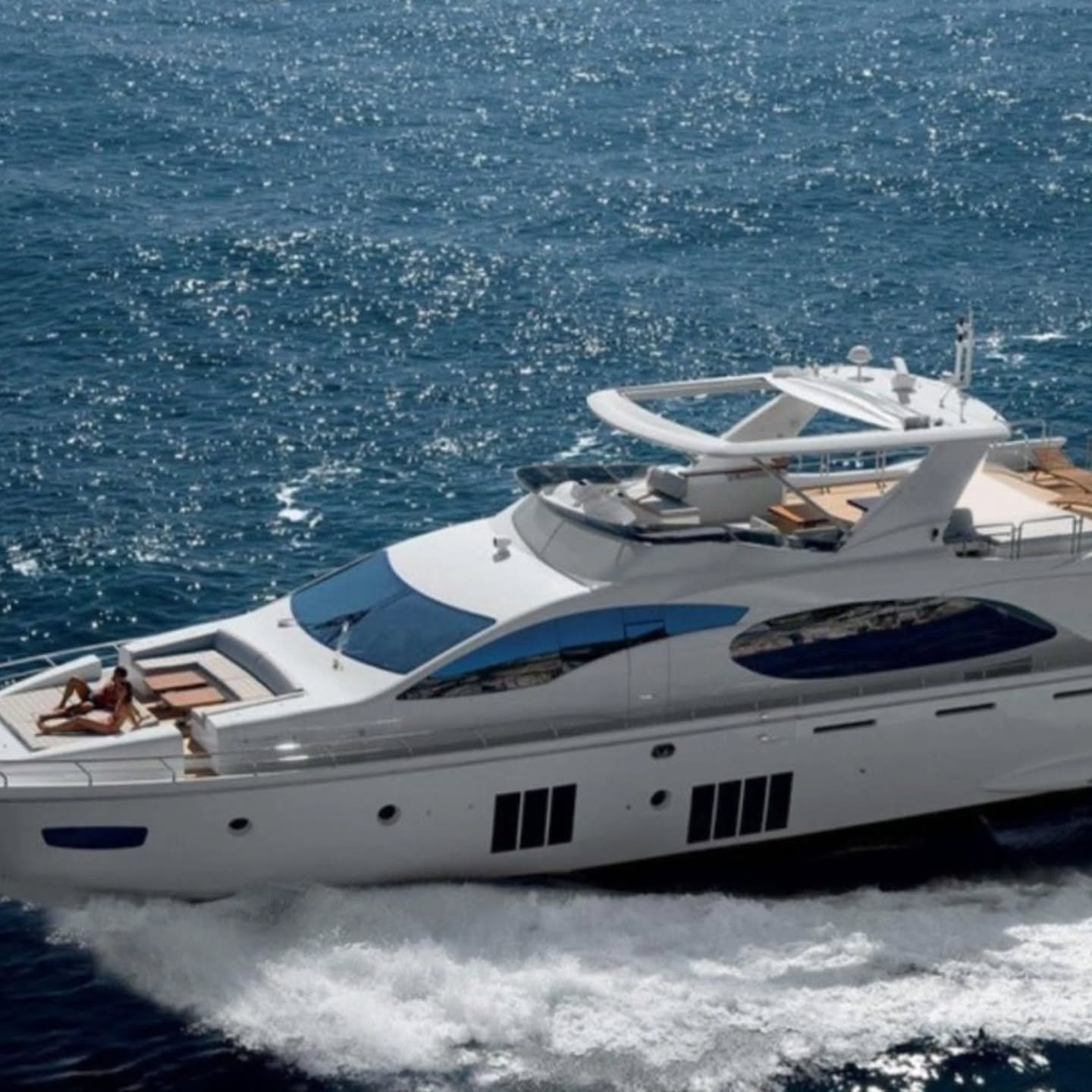 White private yacht cruising across open blue water