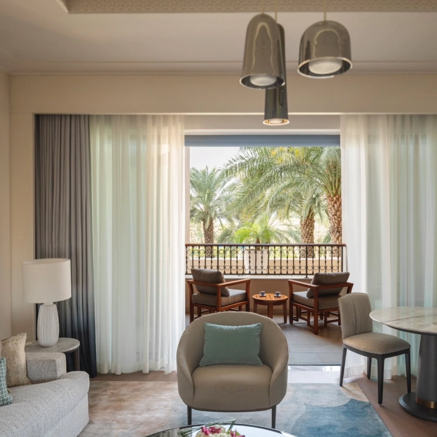 Luxury suite living room with balcony and palm views